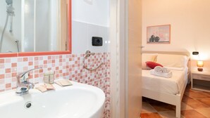 A bathroom with a sink, mirror, and shower. - Domo Mea Rooms- Camera 3 (CABRAS)