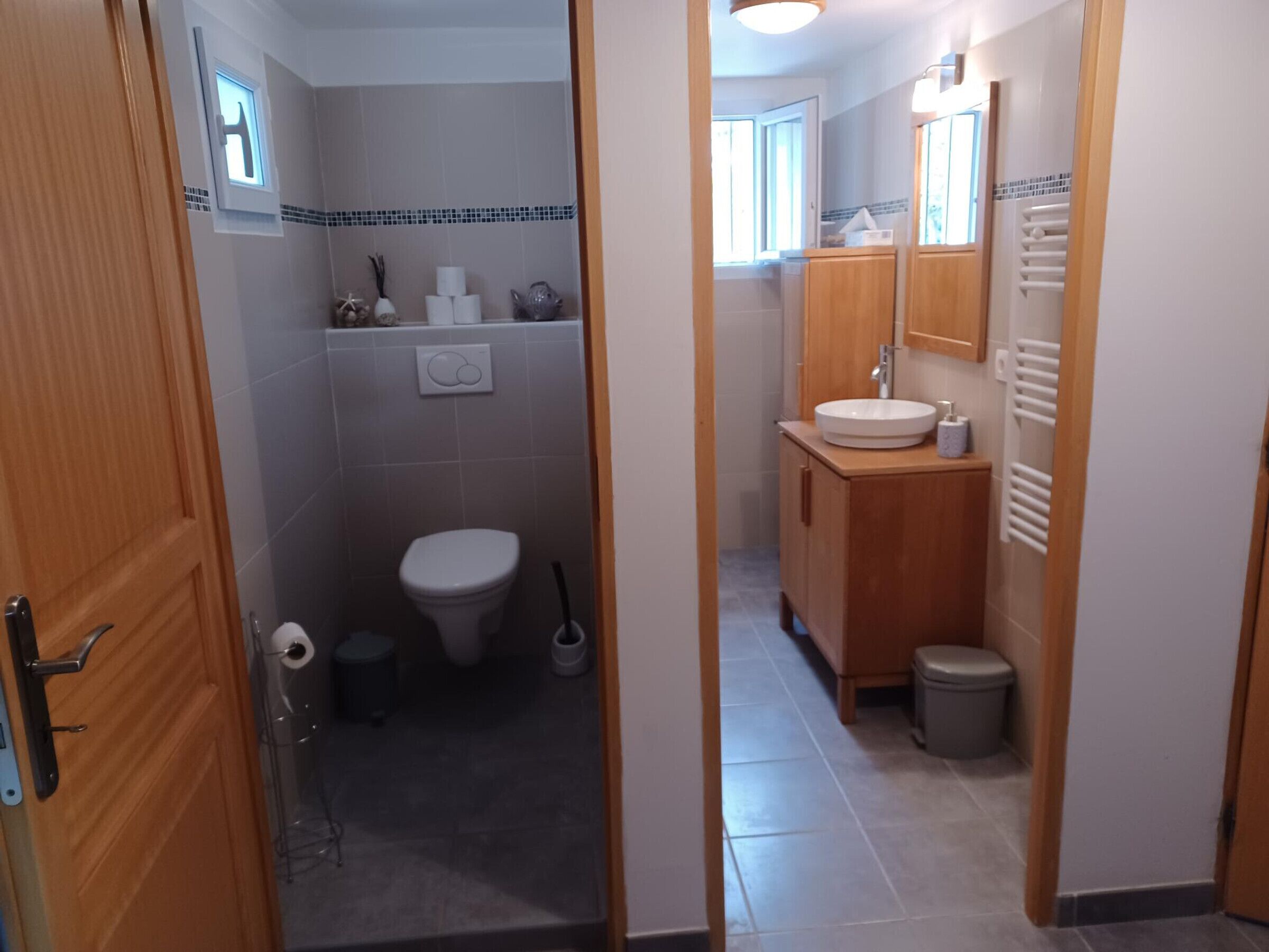 Un baño con inodoro, lavabo y espejo.