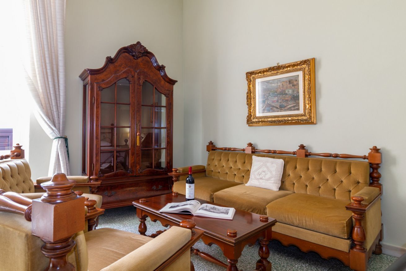 Une pièce au décor traditionnel, avec un meuble en bois, un canapé, une table basse et un tableau encadré au mur.