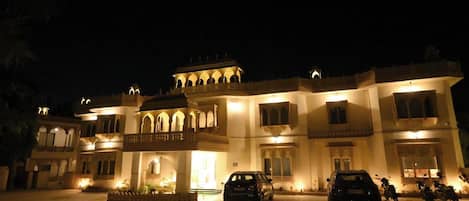 A multi-story building with traditional architecture, featuring arched windows and balconies.