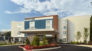 A modern hotel with a flat roof, a stone base, and a sign reading "SPRINGHILL SUITES." - Steps from Truist Park + Free Breakfast & Pool (Atlanta)