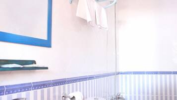 A bathroom with a sink, toilet, and bathtub.