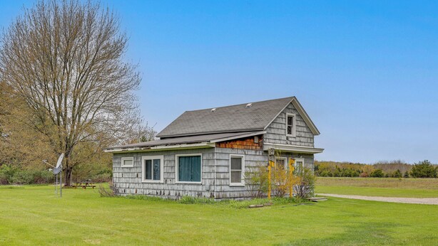 A single-story house with a gabled roof, a front porch, and a small yard. - Rural Bear Lake Home: 6 Mi to Lake Michigan! (Bear Lake)