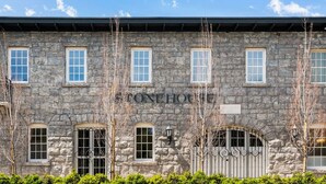 A stone building with the sign "STONEHOUSE" above the entrance.