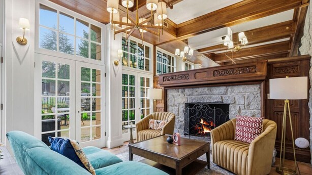 A spacious living room with a fireplace, large windows, and a high ceiling. - Sonoma Wine Country Escape • 1BR Queen Room (Santa Rosa)