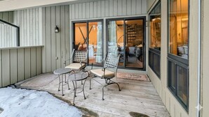 A covered patio with outdoor seating and a glass door leading to an interior space. - New Listing: Pool, Hot Tub, Free shuttle (Keystone)