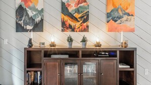 A wooden cabinet with glass doors, books, and decorative items on top. - Freshly updated 1 bedroom in the heart of town close to everything! (Mammoth Lakes)