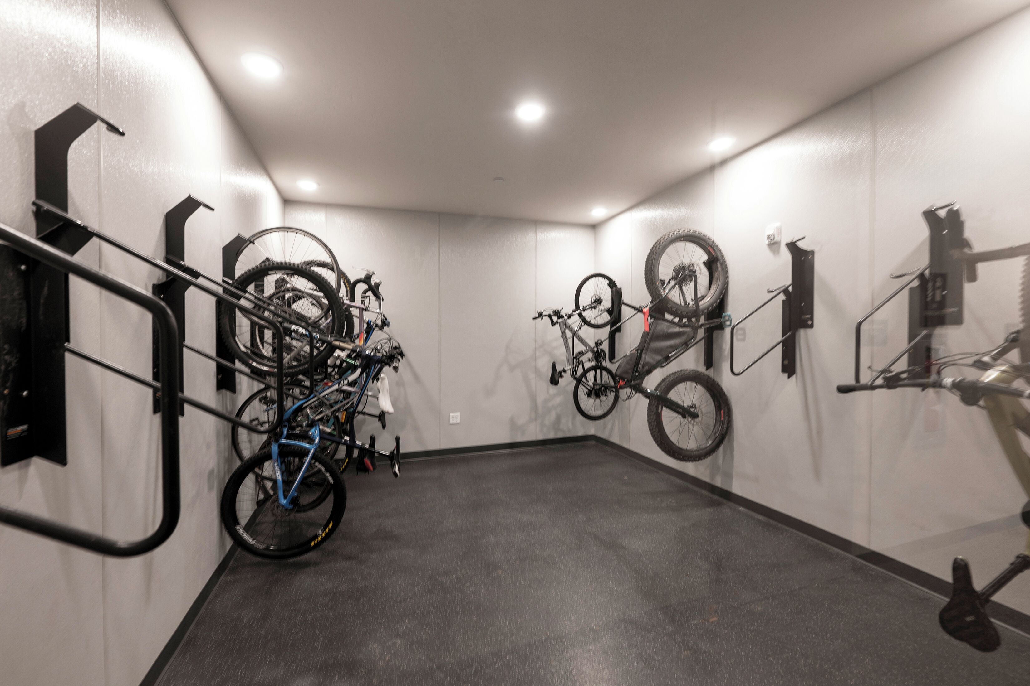 A bike storage area with multiple bicycles and racks.