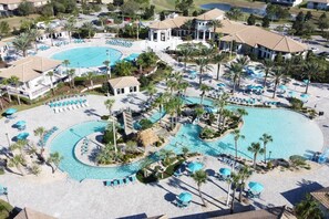 A resort with multiple swimming pools, palm trees, and lounge areas. - Magic & Muggles: Private Pool/Spa, BBQ, Game Room! (Kissimmee)