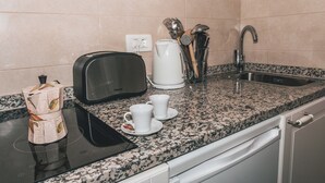 A kitchen with a toaster, a kettle, a sink, and a coffee maker. - Villa Chiara Opatija Apartment Rustica (Ičići)