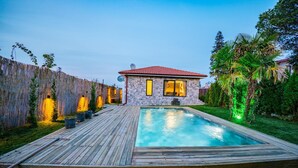 A house with a swimming pool, stone exterior, and a wooden deck. - MONK BY THE LAKE SAPANCA (Sapanca)