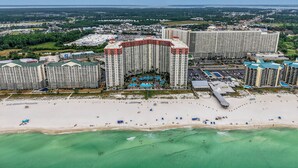 A high-rise hotel with multiple balconies overlooking a beach and ocean. - Shores 1613-King Bed-Beachfront Resort & Amenities (Panama City Beach)