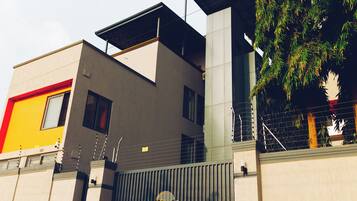 A modern building with a mix of architectural styles, including a flat roof and a sloped section.