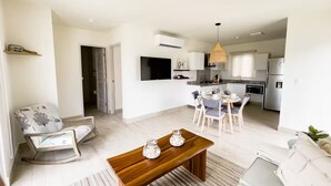 A modern apartment with a dining area, kitchen, and living room. - Seaview Villa -C2-1D- 2 bed, 2 bath (Punta Chame)