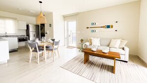 A modern apartment with a dining area, kitchen, and living room. - Seaview Villa -C2-1D- 2 bed, 2 bath (Punta Chame)