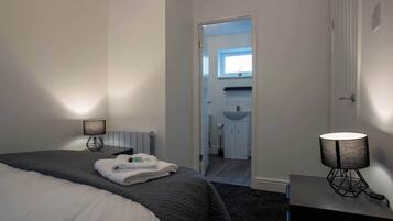 Escritorio, tabla de planchar con plancha, wifi y ropa de cama