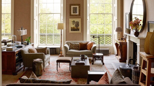 A spacious living room with a large window, a fireplace, and a cozy seating area. - Luxury Georgian Terrace, with superb views of  Arthur`s seat (Edinburgh)