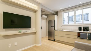 A modern kitchen with a built-in refrigerator, a microwave, and a coffee maker. - Walkable | Near Beiramar Mall #TM103 (Florianópolis)