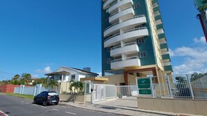 Un edificio de varios pisos con balcones, una entrada con portón y un letrero que indica 'Flamengo Prime 251'.