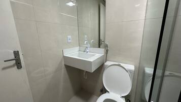 Chuveiro, toalhas de banho, sabonete, shampoo