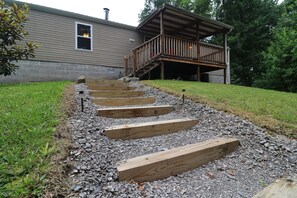 A wooden deck with steps leading to a house. - Adorable 3BR Retreat with Gig-Speed WiFi in Middle Tennessee (Crossville)