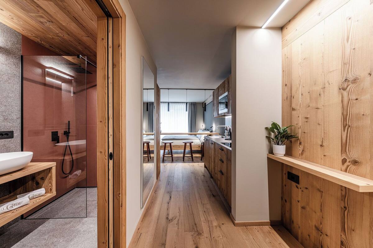 A modern kitchen with wooden cabinets, a built-in oven, and a countertop with a sink.