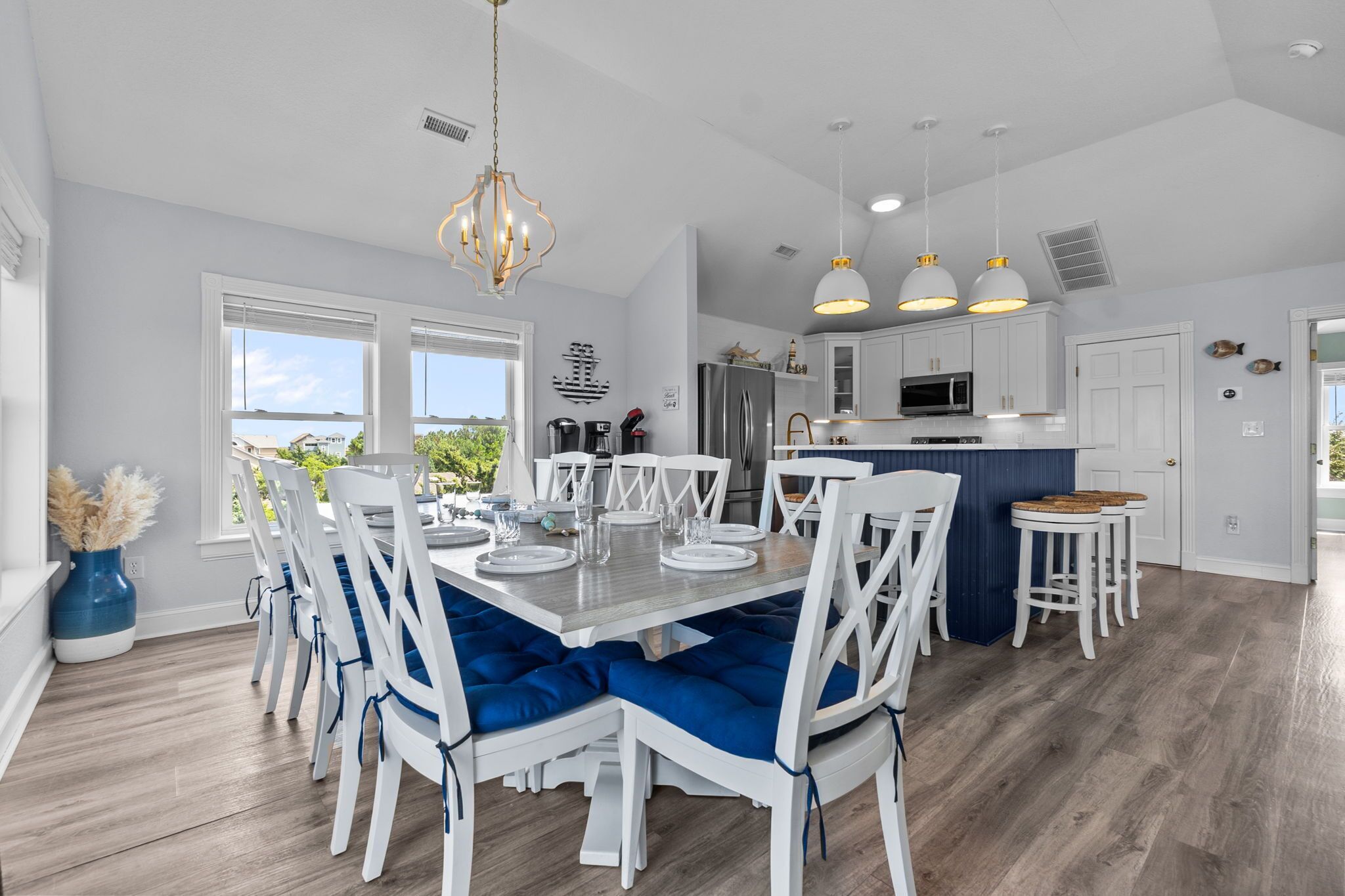 A modern kitchen with white cabinets, a stainless steel refrigerator, and a central island.