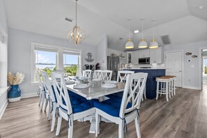 A modern kitchen with white cabinets, a stainless steel refrigerator, and a central island. - Outer Banks Salvo Family Retreat: Private Pool | Private Hot Tub | Dog Friendly (Salvo)