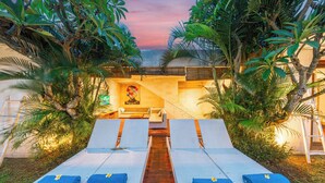 A pool area with lounge chairs and a central pathway. - Stylish 4BR Canggu Villa • Private Pool & Sundeck • 8 Min to Beach (Badung Regency)