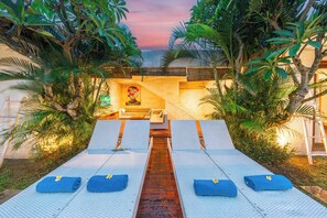 A pool area with lounge chairs and a central pathway. - Stylish 4BR Canggu Villa • Private Pool & Sundeck • 8 Min to Beach (Badung Regency)