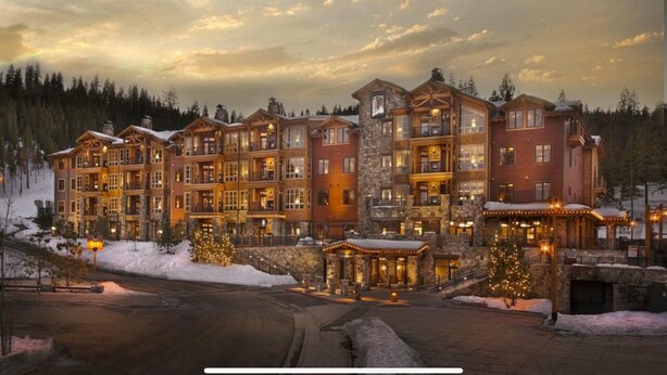 A multi-story lodge with a stone facade, multiple balconies, and a snow-covered landscape. - Luxury Ski-In and Ski-Out 2-Bedroom Villa at Hyatt Northstar Lodge (Truckee)