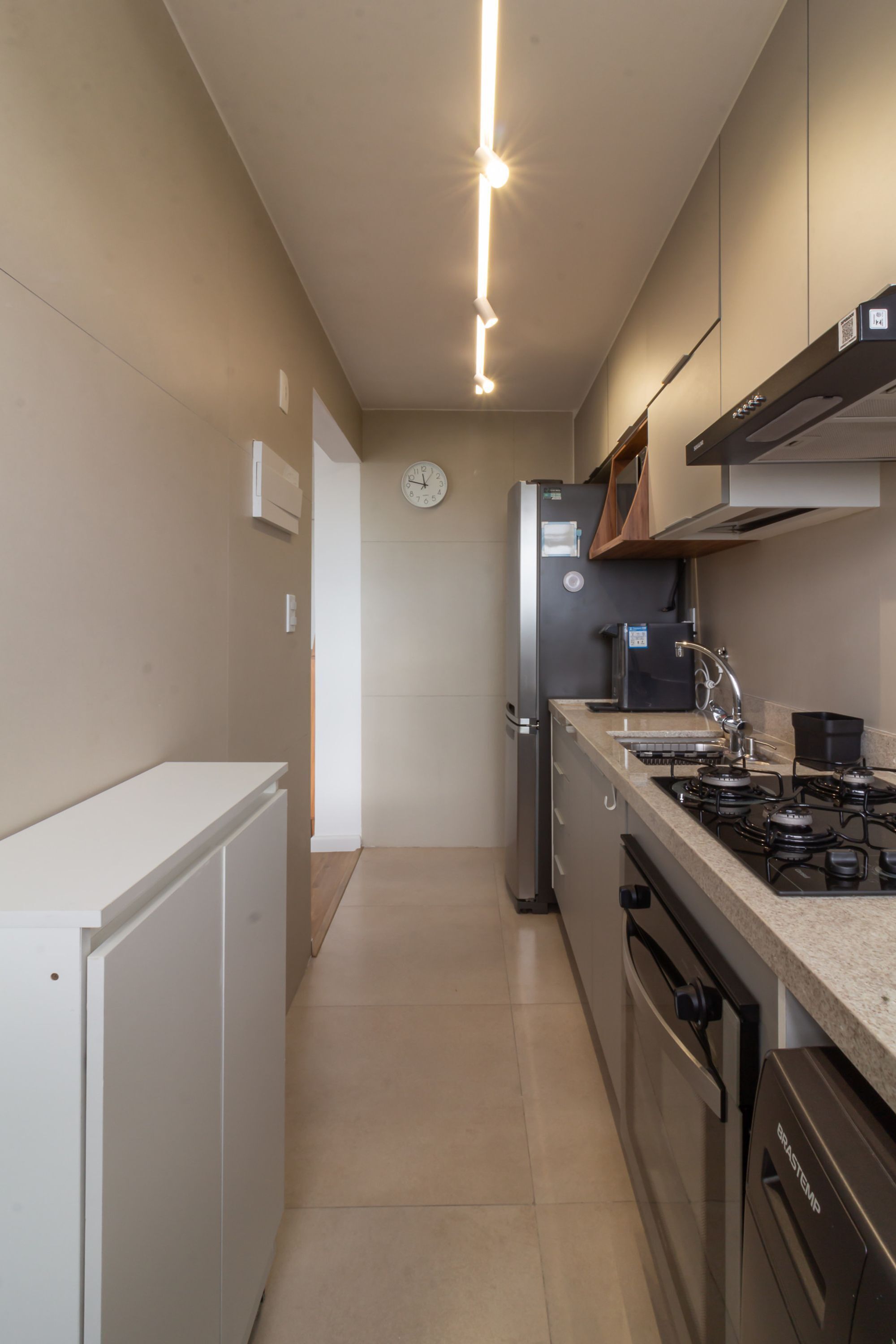 A modern kitchen with a refrigerator, microwave, stove, and dishwasher.