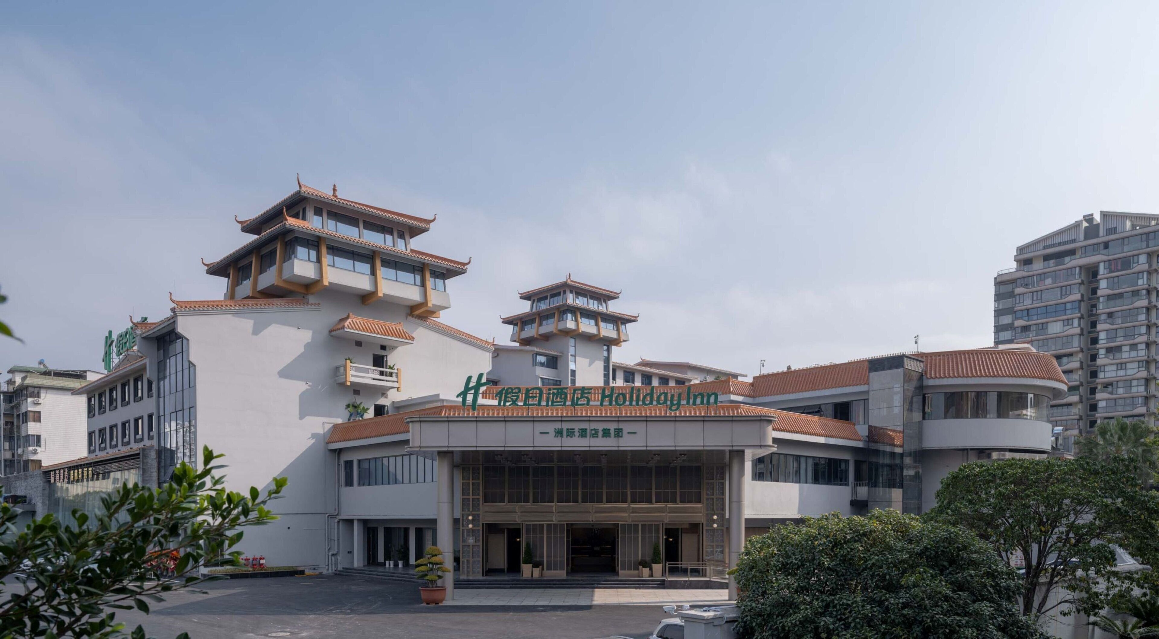 A hotel with traditional architectural elements, including tiered roofs and a central entrance.