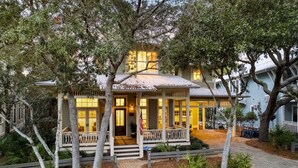 A two-story house with a porch, surrounded by trees. - Close to Communal Pool with LSV (Santa Rosa Beach)