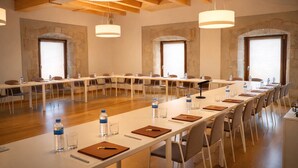 A conference room with long tables, chairs, and water bottles. - Hotel Santuari Balaguer (Balaguer)