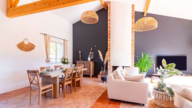 A spacious living area with a dining table, chairs, a sofa, and a TV. - La Tendresse - 10p - Piscine - Jardin (Mondonville)