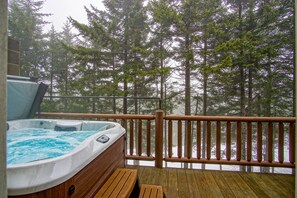 A hot tub on a wooden deck with a view of tall trees and a body of water. - Loggers Run #7: 5 Bedrooms, 3.5 Bath: Slope Side. Overlooks The Ski Trail ! (Snowshoe)