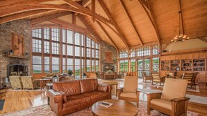 A spacious living room with a fireplace, large windows, and a view of the outdoors. - Soaring Eagle #201: 3 Bedrooms, 2 Full Baths: Slope Side (Snowshoe)