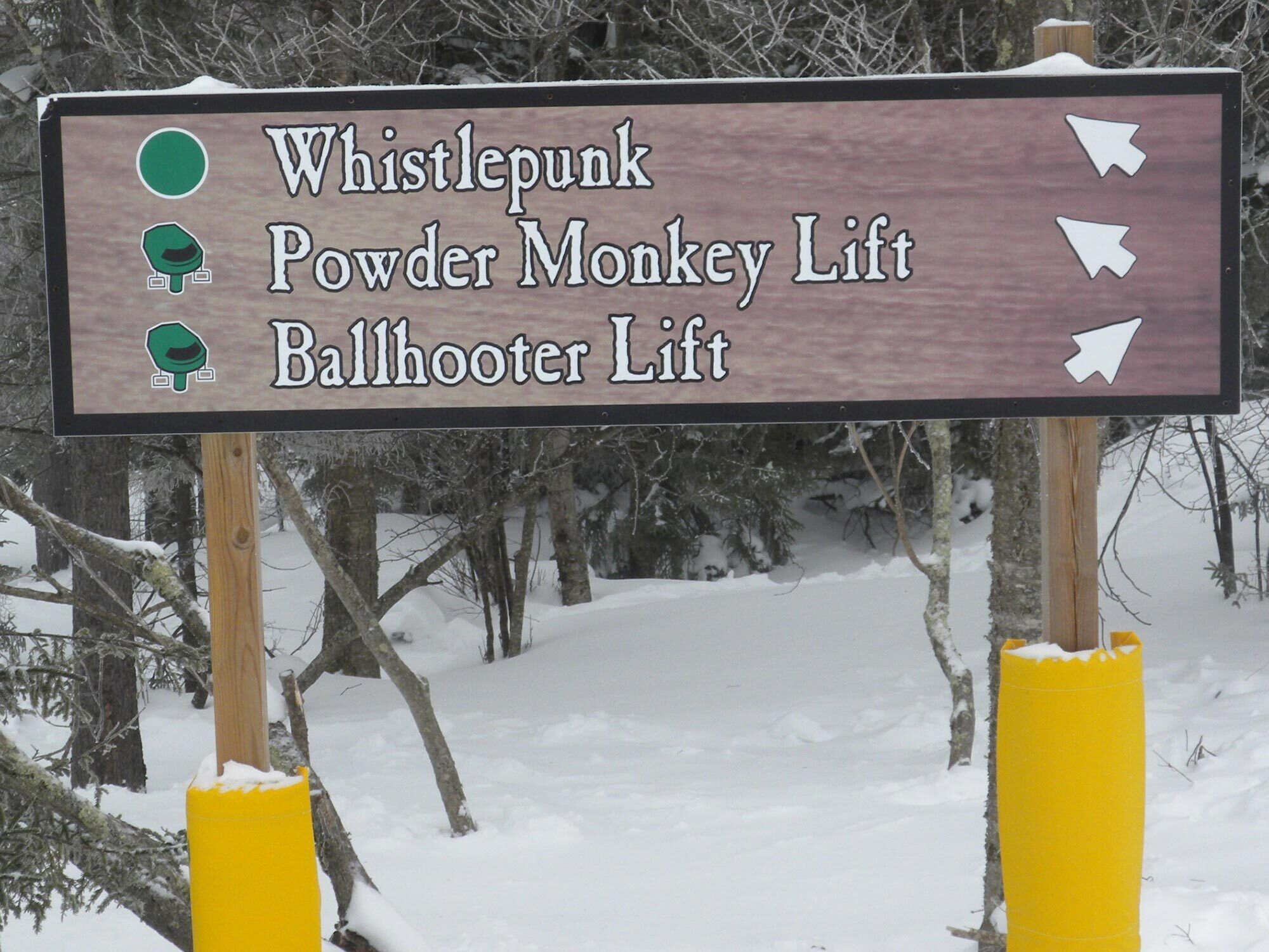 A sign with directions to Whistlepunk, Powder Monkey Lift, and Ballhooter Lift.