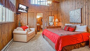 A wooden room with a bed, a chair, a ceiling fan, and a window with blinds. - Wabasso 10 Ski Hideaway Outside Your Door 2 Br Spacious Balcony (Snowshoe)