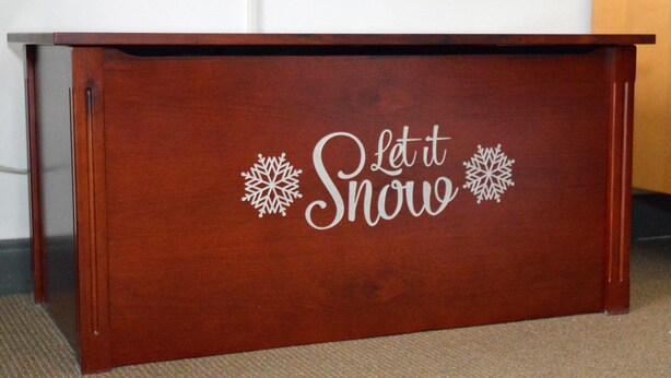 A wooden desk with the text "Let it Snow" and snowflake decorations. - Expedition Station #120: Snowshoe's Premier Slopeside Junior Studio Accommodations (Snowshoe)