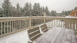 A snow-covered deck with a bench, surrounded by snow-laden trees. - 2 Br: Wabasso 5: 2br, 2 Bath (Snowshoe)