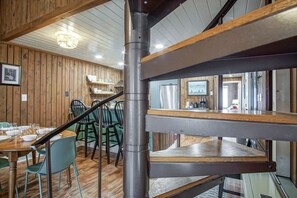 A wooden interior with a staircase, dining area, and kitchen. - 2 Br: Wabasso 5: 2br, 2 Bath (Snowshoe)
