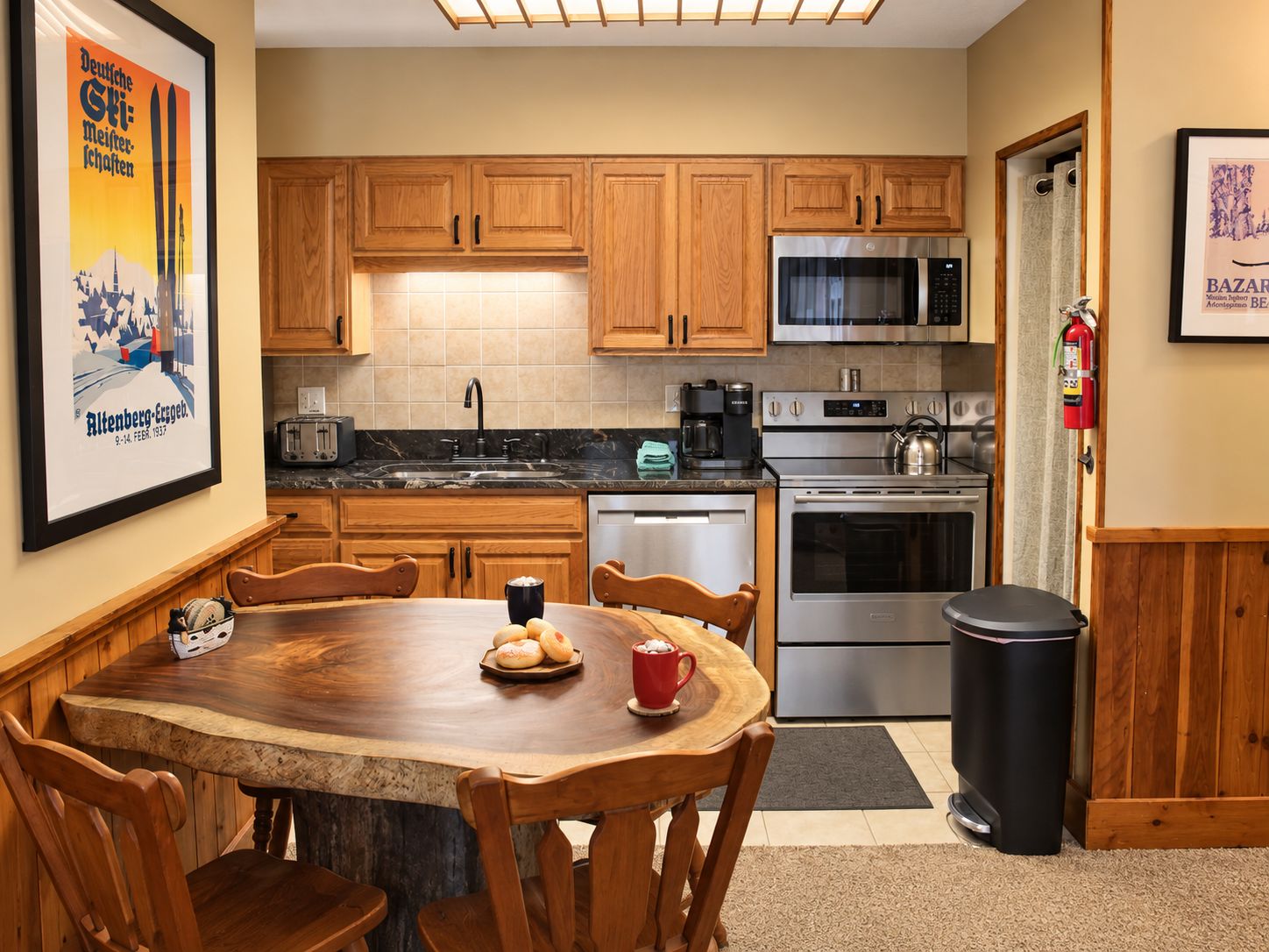 A kitchen with wooden cabinets, a stainless steel refrigerator, a microwave, and a stove.