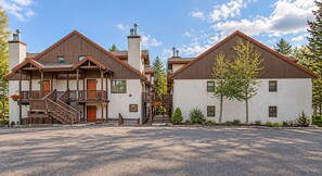 A two-story building with a wooden facade, a balcony, and a sign that reads 'Alpine Village.' - Whistlepunk 45- Modern Comfort With Mountain Charm-1 Bedroom (Snowshoe)
