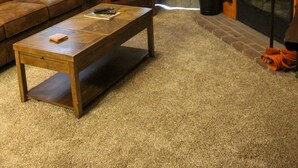 A living room with a wooden ceiling, a fireplace, a brown leather sofa, a wooden coffee table, and a ceiling fan. - Whistlepunk 45- Modern Comfort With Mountain Charm-1 Bedroom (Snowshoe)