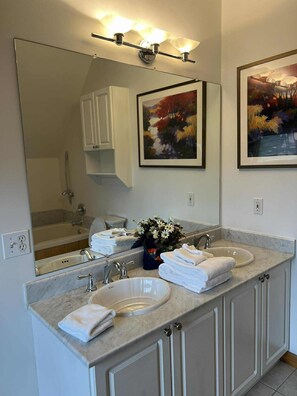A bathroom with a double sink, a large mirror, and two framed paintings. - 4 BR: Timbers #1 Stand Alone Cabin (Snowshoe)