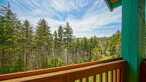 A wooden deck with a view of a forested landscape. - Camp 4 #21: 2 Bedrooms, 2.5 Baths: Slope Side, Gas Fireplace (Snowshoe)