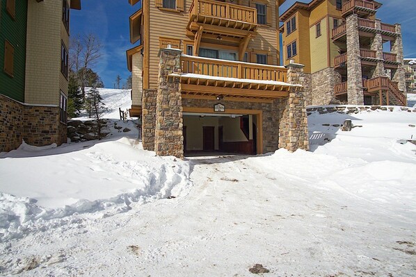 A multi-story building with a stone facade and wooden balconies.