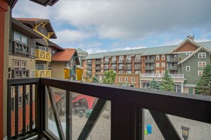 A view from a balcony overlooking a multi-story building with balconies and windows. - Rimfire 322-323: Combined 2 one Bedroom Units, Slopeside (Snowshoe)